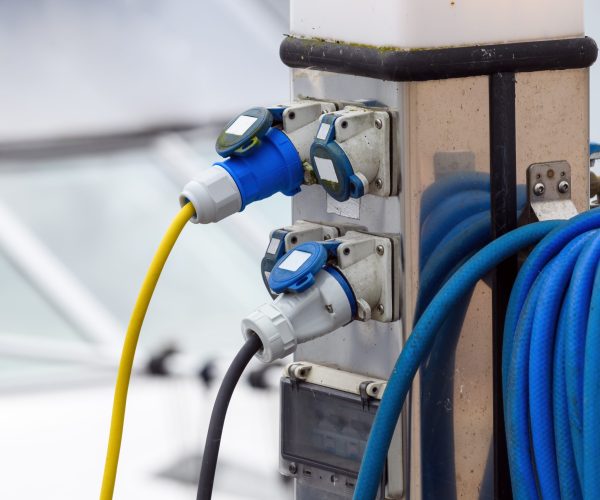 Electric boat charging station at the river quay, selective focus